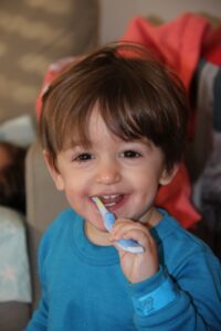 small kid brushing teeth